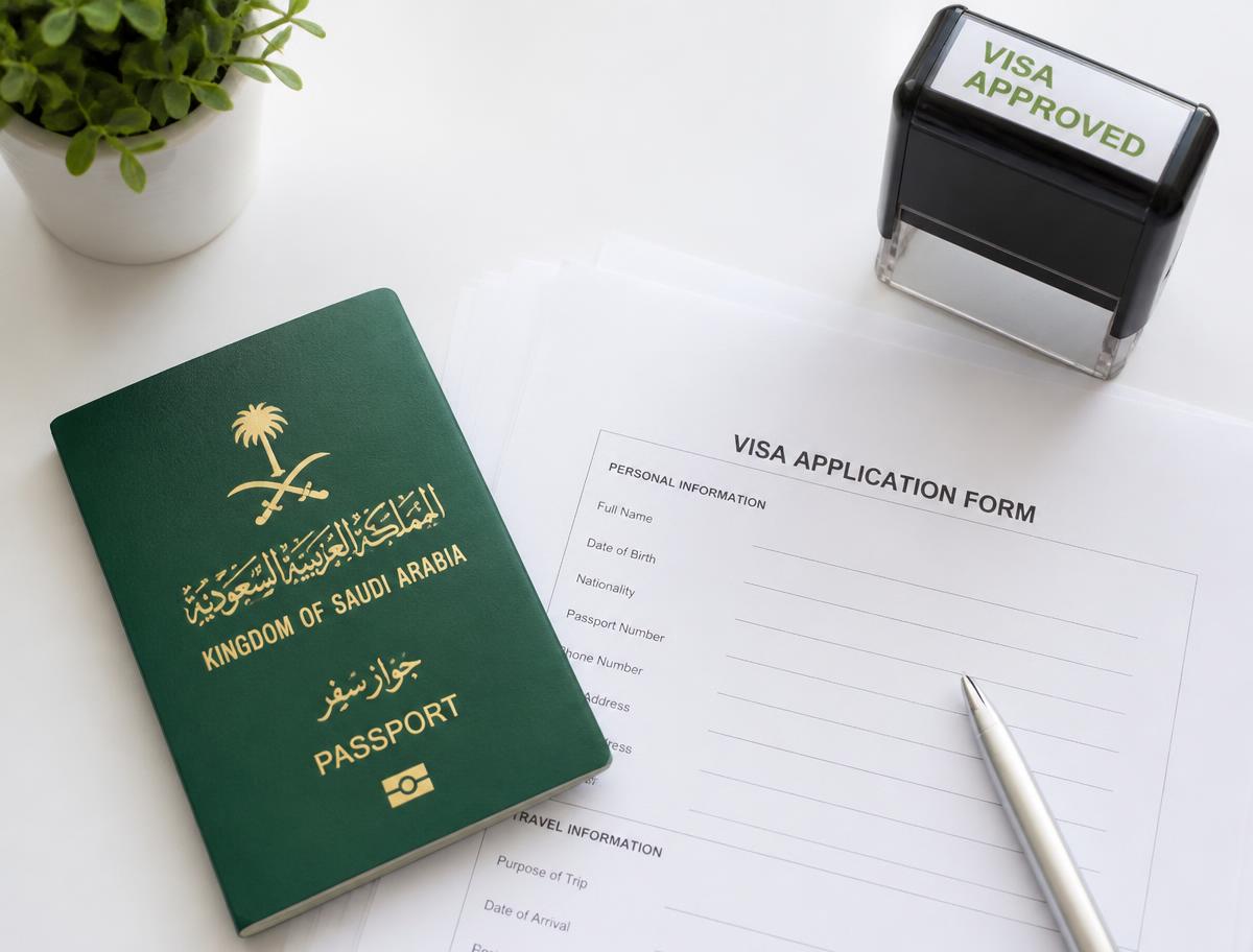 Saudi Arabia passport and visa application form on a white desk